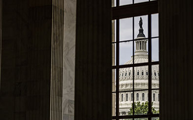 The U.S. Capitol Dome is seen through a window in the in the Rotunda of the Russell Senate Office Building.