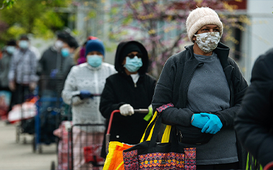 People waiting outside in masks during coronavirus pandemic