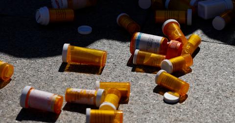 Empty pill bottles on the ground 