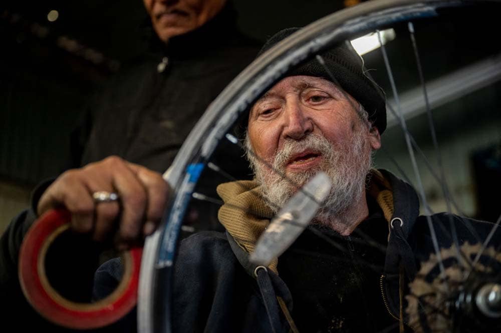 Man works on a customers' bicycle