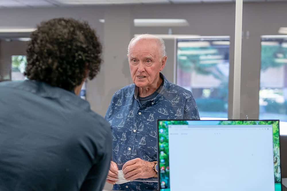 Senior patients at medical office reception desk