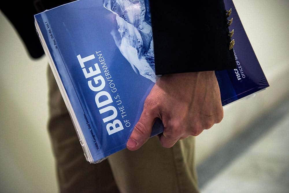 Example of a U.S. Government Budget document held in someone's hand.