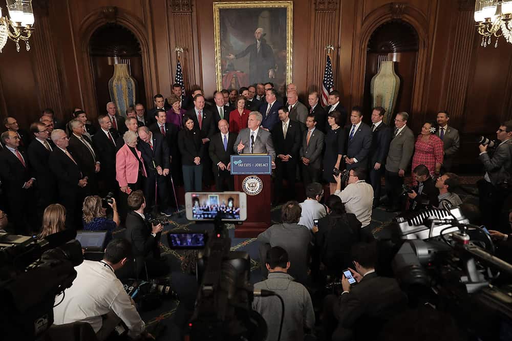 House Majority Leader Kevin McCarthy speaks to the news media with fellow House Republicans following the passage of the Tax Cuts and Jobs Act