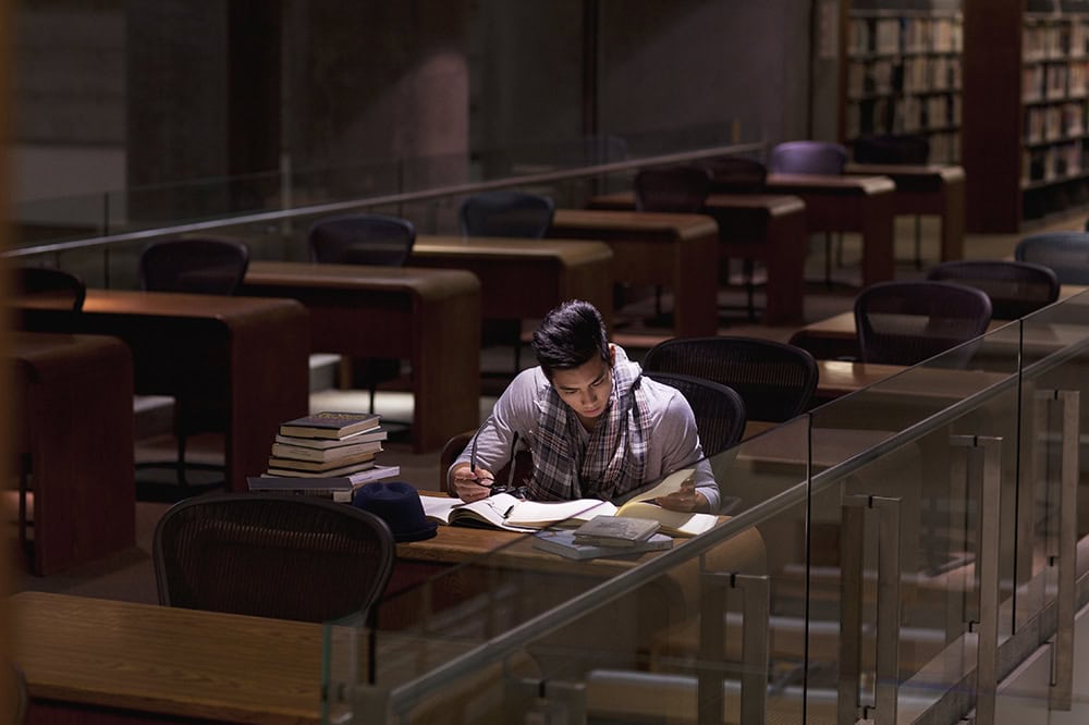 Student working in library at night