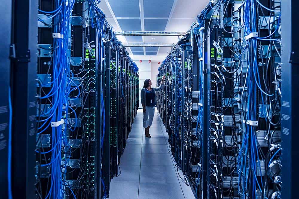 Woman standing in aisle of server room