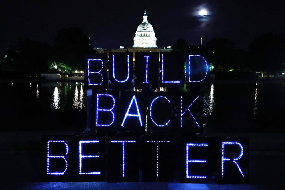 Sign that says Build Back Better in front of Capitol Building