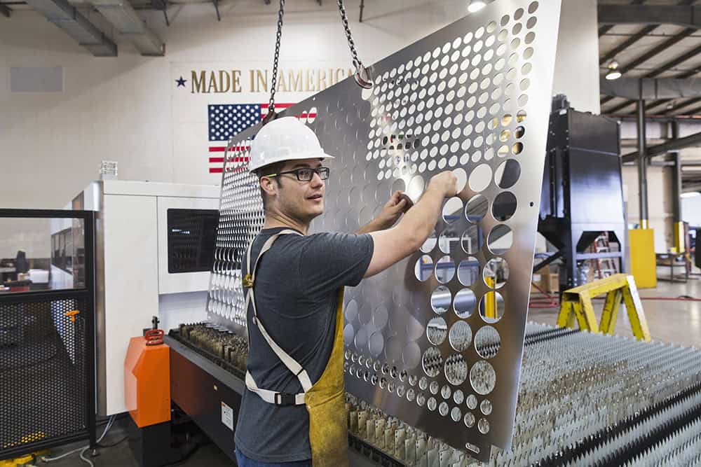 Worker fabricating metal