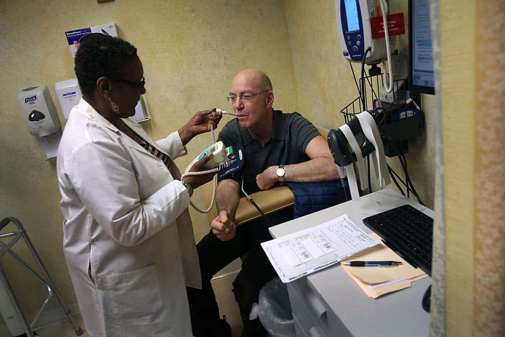 Person receiving aid from a healthcare worker.