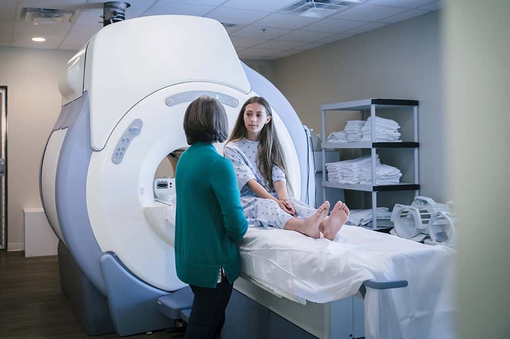 Doctor talking to patient at scanner