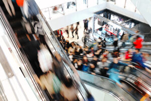 Shoppers on an escalator during rush hour