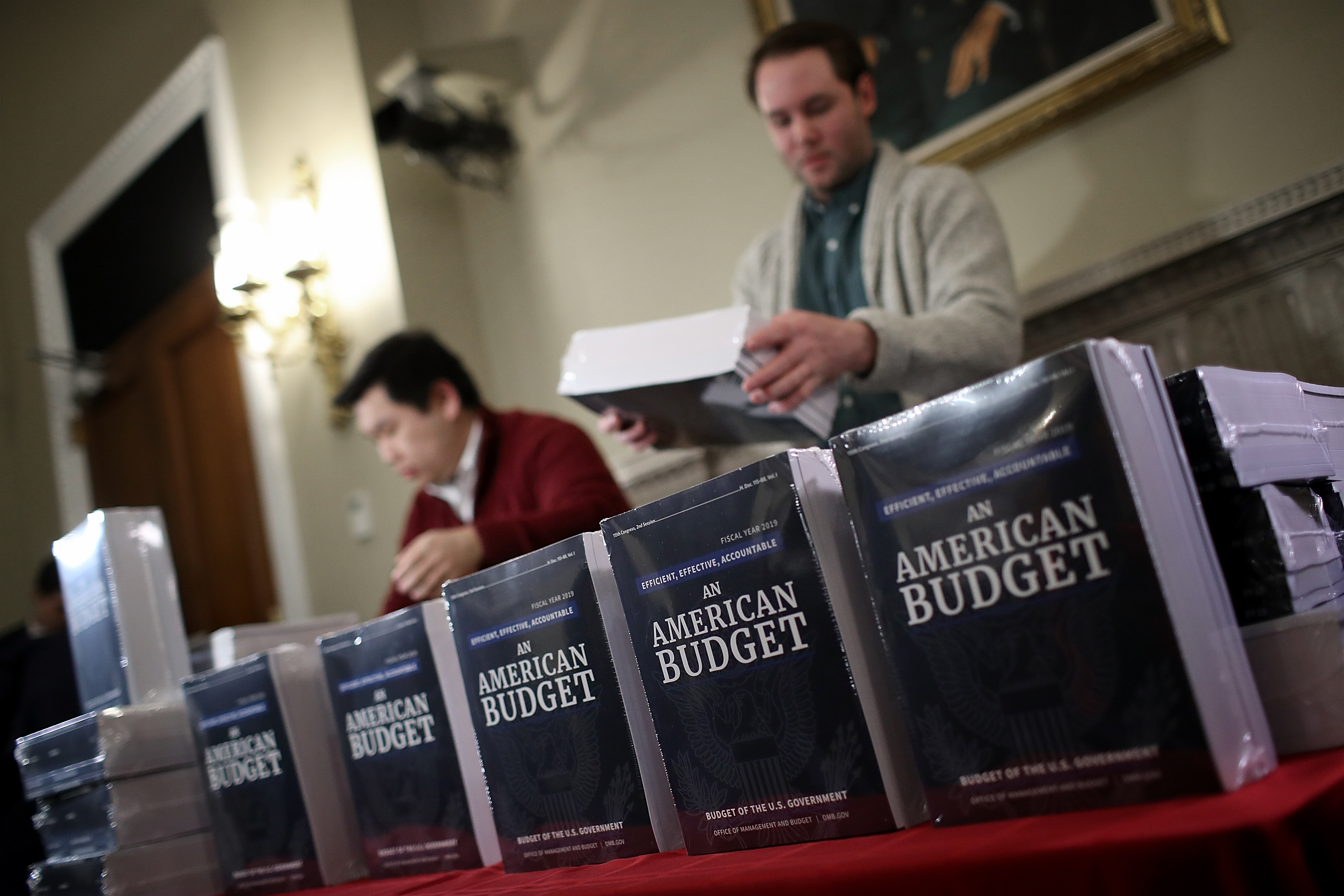 WASHINGTON, DC - FEBRUARY 12: Staff members display recently released printed copies of U.S. President Donald Trump's fiscal year 2019 budget at the House Budget Committee on Capitol Hill February 12, 2018 in Washington, DC. The budget is expected to contain funding requests for the building of a wall on the southern border of the U.S., infrastructure projects, and increased military funding. (Photo by Win McNamee/Getty Images)