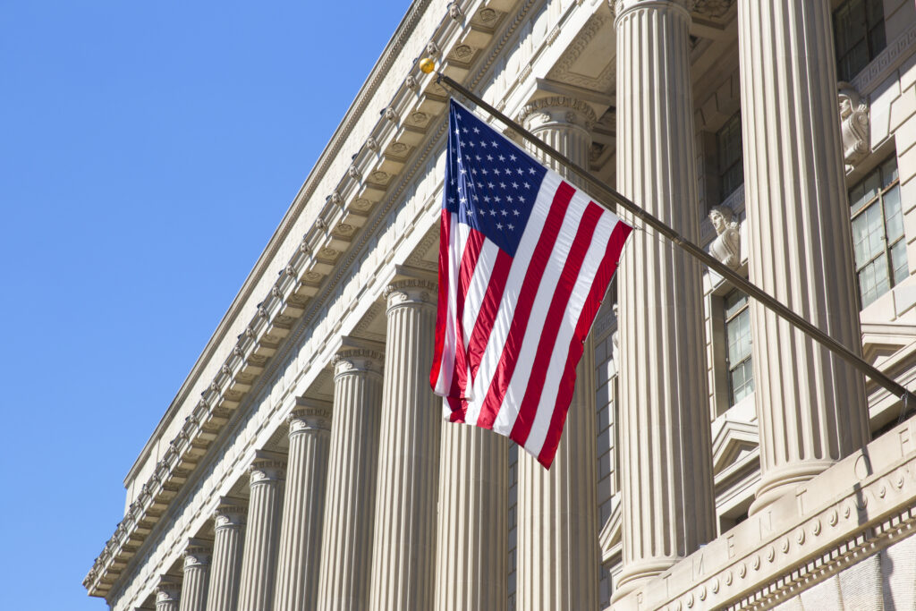 American flag flying outside the Department of Commerce