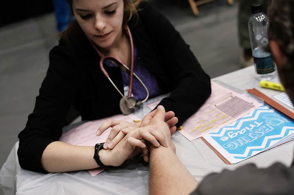 A man has his pulse checked