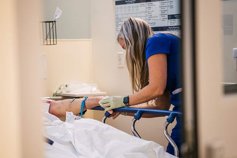 An Emergency Room nurse tends to a patient