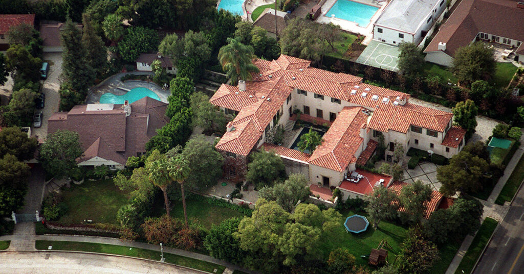 Image is an aerial view of a mansion in a wealthy neighborhood.