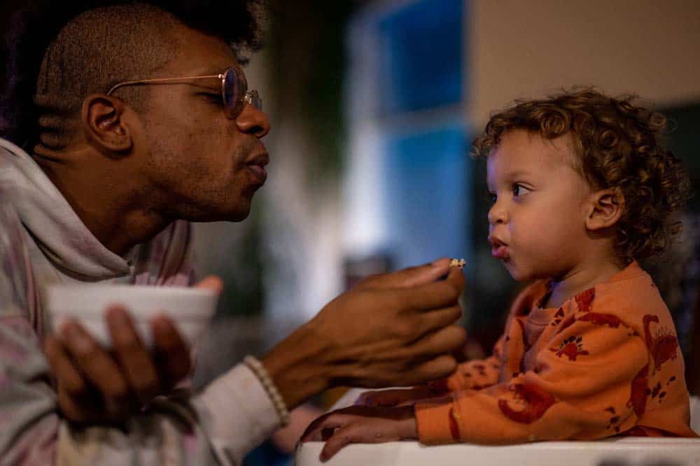 Person feeding a child